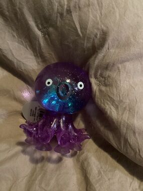 Purple Galaxy Octopus squishy with suction cups on the bottom.